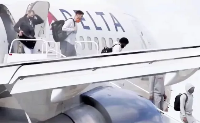Utah Jazz players exit the plane following the emergency landing